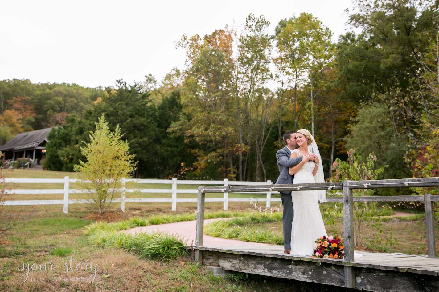 chic barn wedding bride and groom on rustic bridge